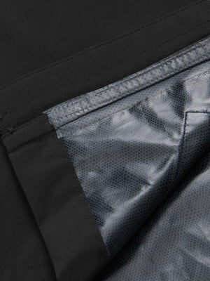Close-up texture of black waterproof lightweight rain jacket with hood fabric showing water-repellent weave detail.