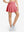 Front lower body shot of model wearing pink women's high waisted golf skirts with 4 inner pockets