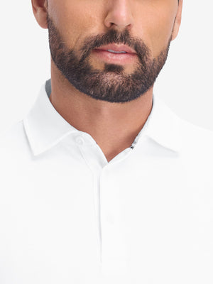 Front shot from nose to chest of model wearing white dry fit waffle textured collared golf shirts