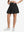 Front lower body shot of model wearing black women's high waisted golf skirts with 4 inner pockets
