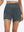 Front lower body shot of model wearing dark grey women's high waist 2 in 1 quick dry shorts with 7 pockets