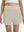 Front lower body shot of model wearing oyster gray women's gym golf shorts with liner pocket