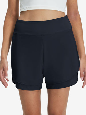 Front lower body shot of model wearing navy blue women's gym golf shorts with liner pocket