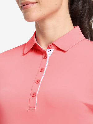 Front shot from nose to chest of model wearing pink women's 5 buttons collared polo shirts