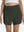 Front lower body shot of model wearing army green women's gym golf shorts with liner pocket