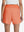 Back lower body shot of model wearing peach pink women's gym golf shorts with liner pocket