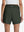 Back lower body shot of model wearing army green women's gym golf shorts with liner pocket