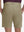Back lower body shot of model wearing khaki flat front hybrid golf shorts