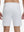Back lower body shot of model wearing white 4 way stretch breathable workout athletic shorts