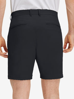 Back lower body shot of model wearing black flat front flex cotton blend golf shorts