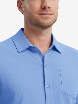 Model front view from nose to chest wearing blue cotton blend plain shirt.