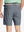 Back view of youth in navy Heather Performance Golf Shorts, highlighting rear design and fit