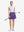 Front full body shot of model with golf gear wearing dark purple women's moisture-wicking athletic tennis skirts