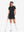 Front full body with golf club in black of women's lightweight golf dress with 2 pockets.