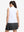 Back upper body shot of model wearing white women's moisture-wicking mock neck sleeveless golf tops