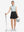 Front full body shot of model wearing black women's high waisted golf skirts with 4 inner pockets
