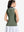 Back upper body shot of model wearing mossy stone women's collared v neck quick dry tank tops