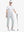 Full-body front view wearing golf hat and holding club in GLACIER GREY Women's 7/8 Ankle Golf Track Pants.