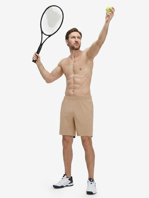 Front full body shot of model exercising in light khaki 4 way stretch breathable workout athletic shorts