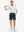 Front full body shot of model wearing navy flat front flex cotton blend golf shorts