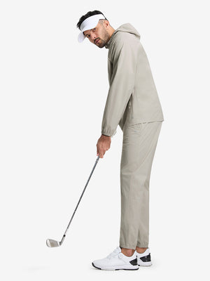 Full body shot of model playing golf in khaki grey waterproof lightweight rain jacket with hood