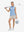Front full body with golf club in light blue of women's 4 buttons golf polo shirts.
