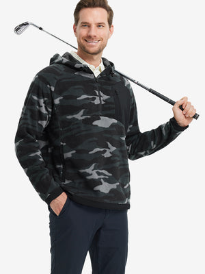 Model holding a golf club, dressed in Black Camo Quarter Zip Polar Fleece Sweatshirt, sporty fit.