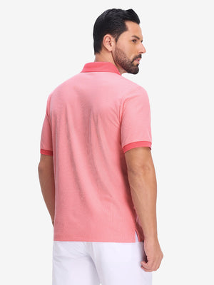 Front upper body shot of model wearing brick red moisture wicking jacquard golf shirts