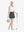 Front full body shot of model exercising in white women's athletic quarter zip tank tops