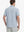 Back view of model in Navy Blue Stripe Performance Stripe Golf Shirt