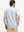 Back half-body of model in white blue florals stretch printed collarless henley golf shirts
