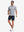 Front full body shot of model wearing navy white comfy breathable pin-stripe texture golf polos
