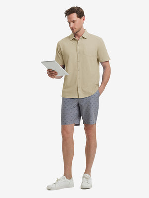 Full-body view of model holding takeaway drink cup in khaki cotton blend plain shirt.