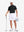 Front full body shot of model wearing black dry fit waffle textured collared golf shirts