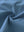 Close-up fabric detail of 4-way stretch performance solid shorts, smooth texture with flexible grayish blue feel
