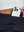 Detail view of back pocket on navy blue women's stretch a-line golf skort with 7 pockets