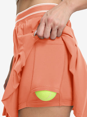 Detail view of inner pocket on peach pink women's moisture-wicking athletic tennis skirts