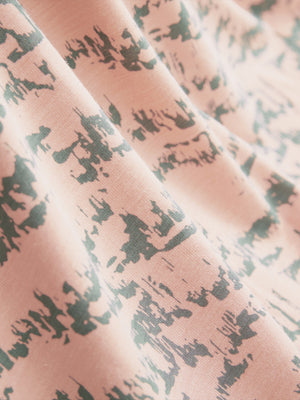 Fabric detail of Popular heather print polo with soft blended texture in light orange massif