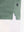 Hem detail close-up in celadon green heather of performance heather contrast collar polo shirts.