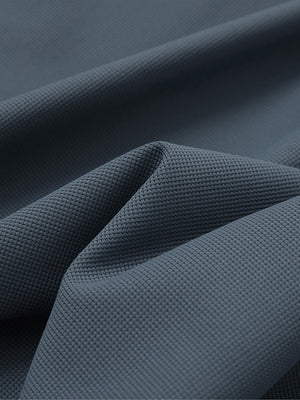 Close-up texture of dark grey waffle texture 1/4 zip pullover fabric showing detailed waffle knit material and weave.