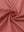 Close-up of coral pink women's performance solid polo fabric texture.