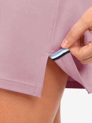 Hem stitching detail close-up in pink of women's lightweight golf dress with 2 pockets.