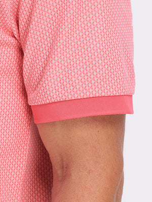 Detail view of hem on brick red moisture wicking jacquard golf shirts