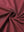 Close-up of wine 4 way stretch jacquard polo fabric texture highlighting intricate woven pattern and elasticity.