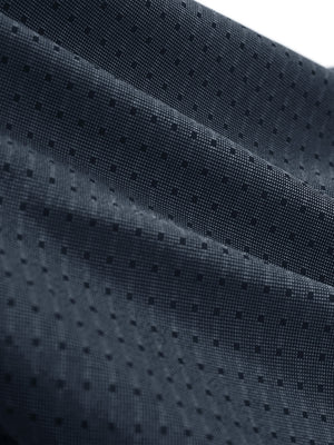 Close-up texture of dark blue classic lightweight jacquard golf shirts fabric showing jacquard weave detail.