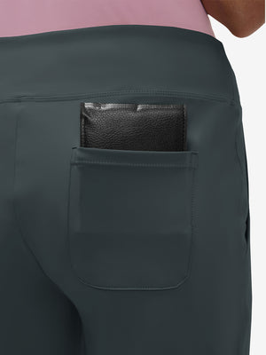 Back view of pocket on dark grey women's high waist stretch golf pants with pockets