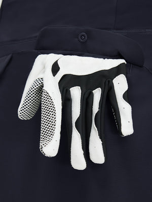 Detail view of pocket on navy blue women's stretch a-line golf skort with 7 pockets