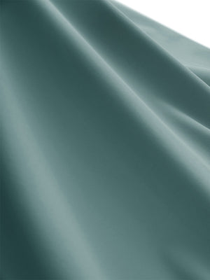 Close-up texture of dusty blue women's moisture-wicking mock neck sleeveless golf tops fabric showing breathable weave detail.