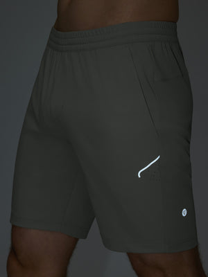 Detail of glow in the dark feature on iron grey 4 way stretch breathable workout athletic shorts