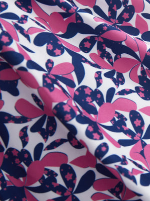 Close-up texture of rose red florals women's sleeveless q-zip print quick dry golf tops fabric showing detailed print and quick dry weave.
